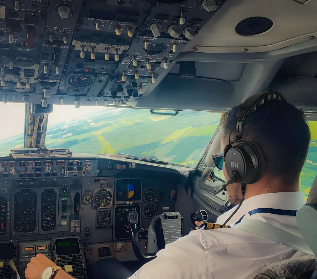 The male pilot is flying with BH Alpha Bluetooth Aviation Headset